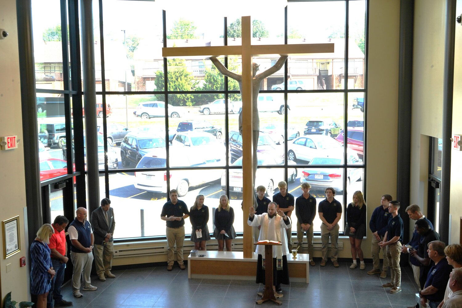Father Paul Clark, chaplain of Helias Catholic High School in Jefferson City, blesses and rededicates the renewed “Crucifix Entrance” to the school during a Sept. 7 ceremony.